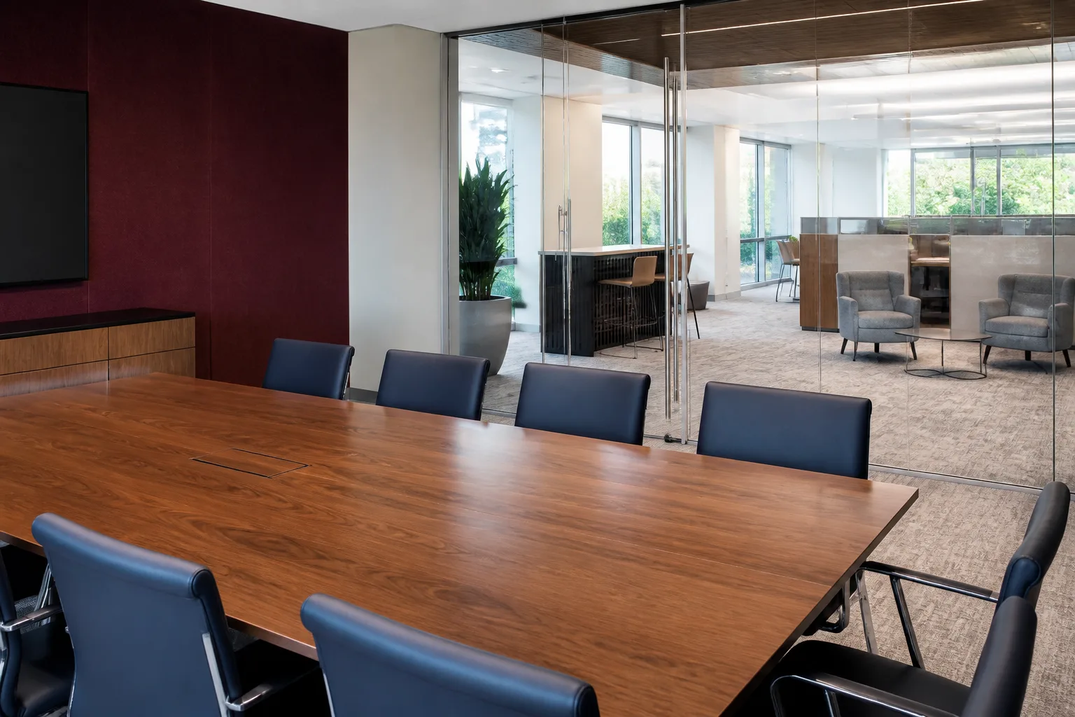 Wood conference table overlooking a Napa office lounge